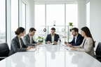 a group of people in a conference room with blank books in a well lite clean backgroudn 